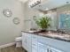 Elegant bathroom with granite counters, dual sinks, and decorative wall mirrors at 39 Lake Dr, Debary, FL 32713