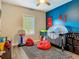 Spacious bedroom featuring blue accent wall, Spider-Personal decor, playful elements, and natural light at 39 Lake Dr, Debary, FL 32713