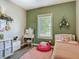 Cozy bedroom with pink accents, a vanity, wood-look floors, and a window with blinds at 39 Lake Dr, Debary, FL 32713
