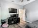 Bright bedroom with a dedicated workspace including desk, computers, and television at 39 Lake Dr, Debary, FL 32713