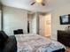 Bedroom featuring wood-look floors, closet access, and a TV mounted above a dark wood dresser at 39 Lake Dr, Debary, FL 32713