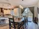 Elegant dining area with stylish pendant lights and access to the kitchen and outdoor patio at 39 Lake Dr, Debary, FL 32713