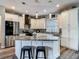 Stylish kitchen featuring stainless steel appliances, granite counters, pendant lights, and large island at 39 Lake Dr, Debary, FL 32713