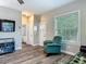 Comfortable living room with a chair, views to the bathroom, and a view outside at 39 Lake Dr, Debary, FL 32713