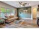 Cozy living room featuring a comfortable sofa, coffee table, and views of the outdoors at 39 Lake Dr, Debary, FL 32713