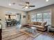 Open-concept living room with a comfortable couch, area rug, and connecting dining and kitchen areas at 39 Lake Dr, Debary, FL 32713