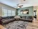 Comfortable living room with large windows, ceiling fan, and sectional sofa, perfect for relaxation at 39 Lake Dr, Debary, FL 32713