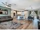 Spacious living room with ceiling fan, dining table, kitchen island, and access to outdoor living area at 39 Lake Dr, Debary, FL 32713