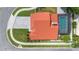 Aerial view of home with red tile roof, screened pool and paver driveway at 3904 Woodsfield Ct, Orlando, FL 32822