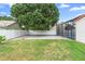The home has a manicured lawn, a large tree, and a pool covered by a screen at 3904 Woodsfield Ct, Orlando, FL 32822