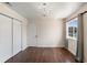 Charming bedroom with dark wood floors, a closet, and an elegant chandelier at 3904 Woodsfield Ct, Orlando, FL 32822