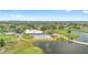 Aerial view of the community clubhouse, pool, golf course, and scenic lake at 3904 Woodsfield Ct, Orlando, FL 32822