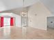 Elegant foyer with high ceilings, ceramic flooring, a modern chandelier, and striking red curtains at 3904 Woodsfield Ct, Orlando, FL 32822