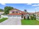 Stunning two-story home with a red tile roof and a three-car garage at 3904 Woodsfield Ct, Orlando, FL 32822