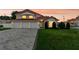 Charming two-story home with three-car garage and manicured lawn at sunset at 3904 Woodsfield Ct, Orlando, FL 32822