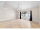 Bright, spacious living room with tile flooring, a modern chandelier, and large windows overlooking the pool at 3904 Woodsfield Ct, Orlando, FL 32822