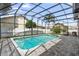 Screened-in pool features ample patio space and clear blue water, perfect for relaxing at 3904 Woodsfield Ct, Orlando, FL 32822