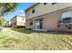 The back yard features grass, sliding doors and a patio at 3917 Pemberly Pines Cir, St Cloud, FL 34769