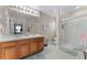 Bright bathroom featuring double sinks, cherry wood cabinets and a walk-in shower at 3917 Pemberly Pines Cir, St Cloud, FL 34769
