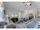 Cozy living room featuring a comfortable sofa, ceiling fan, and stylish decor at 3917 Pemberly Pines Cir, St Cloud, FL 34769