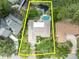 Aerial shot outlines a property with pool near the lake, emphasizing its spacious outdoor living area at 3960 Lake Mira Dr Dr, Orlando, FL 32817