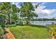 Lush backyard with manicured lawn gently sloping to the lake waters edge at 3960 Lake Mira Dr Dr, Orlando, FL 32817