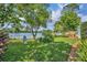 Lush backyard with manicured lawn and mature trees overlooking a serene lake view, perfect for relaxing at 3960 Lake Mira Dr Dr, Orlando, FL 32817