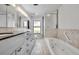 Bright bathroom with marble countertops, a luxurious soaking tub, and a sleek glass shower at 3960 Lake Mira Dr Dr, Orlando, FL 32817