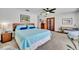 Airy bedroom with plush carpeting, a cozy queen bed, and stylish wood furnishings at 3960 Lake Mira Dr Dr, Orlando, FL 32817