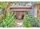 Inviting front entrance with a tiled walkway leading to a double-door entry, complemented by lush landscaping at 3960 Lake Mira Dr Dr, Orlando, FL 32817