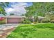 Charming single-story home with a well-manicured lawn and a two car garage at 3960 Lake Mira Dr Dr, Orlando, FL 32817