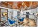 Modern eat-in kitchen with custom wood ceiling, white cabinets, stainless steel appliances, and unique floor tiles at 3960 Lake Mira Dr Dr, Orlando, FL 32817