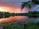 Picturesque lake view at sunset, reflecting the vibrant colors of the sky at 3960 Lake Mira Dr Dr, Orlando, FL 32817