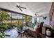 Relaxing lanai offering scenic views of the lake, with comfortable seating and potted plants, creating a serene retreat at 3960 Lake Mira Dr Dr, Orlando, FL 32817