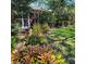 Lush landscaping with various plants and greenery surrounds this home, adding to the curb appeal at 3960 Lake Mira Dr Dr, Orlando, FL 32817