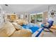 Bright living room featuring stylish furnishings, a modern glass table, and sliding glass doors that reveal outdoor scenery at 3960 Lake Mira Dr Dr, Orlando, FL 32817