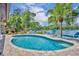 Inviting backyard pool with lush landscaping and scenic lake views at 3960 Lake Mira Dr Dr, Orlando, FL 32817