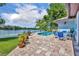 Inviting backyard pool area with a patio overlooking a serene lake view and lush greenery at 3960 Lake Mira Dr Dr, Orlando, FL 32817