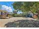 Large backyard with mature trees, wooden deck, brick path, and storage shed at 418 W Princeton St, Orlando, FL 32804