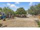 Expansive backyard with mature trees, wooden fence, and a charming brick walkway at 418 W Princeton St, Orlando, FL 32804