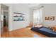 Spacious bedroom with hardwood floors, bright natural light, and whimsical decor at 418 W Princeton St, Orlando, FL 32804