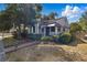 Quaint home with manicured lawn, mature trees, and classic awning over the front door at 418 W Princeton St, Orlando, FL 32804