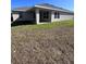 Exterior view of a home's backyard, showcasing a covered lanai at 4264 Sagefield Dr, St Cloud, FL 34773