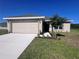Charming single-Gathering home featuring a manicured lawn, neutral color palette, and a two-car garage at 4264 Sagefield Dr, St Cloud, FL 34773