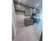 Modern kitchen showcasing gray cabinets, granite countertops, and stainless steel appliances at 4264 Sagefield Dr, St Cloud, FL 34773