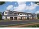 Charming townhome showcases a blend of stone and siding, enhanced by private garages and inviting entryways at 4283 Campsite Loop, Orlando, FL 32824