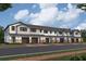 A row of modern townhomes features a mix of stone and siding, each with private garages and inviting entryways at 4283 Campsite Loop, Orlando, FL 32824