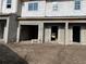 Unfinished townhome exterior featuring gray block construction and window openings at 4283 Campsite Loop, Orlando, FL 32824