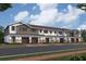 A row of modern townhomes features a mix of stone and siding, each with private garages and inviting entryways at 4283 Campsite Loop, Orlando, FL 32824
