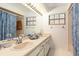 Bathroom featuring a double sink vanity and updated lighting fixtures at 429 Kimberly Ct, Sanford, FL 32771
